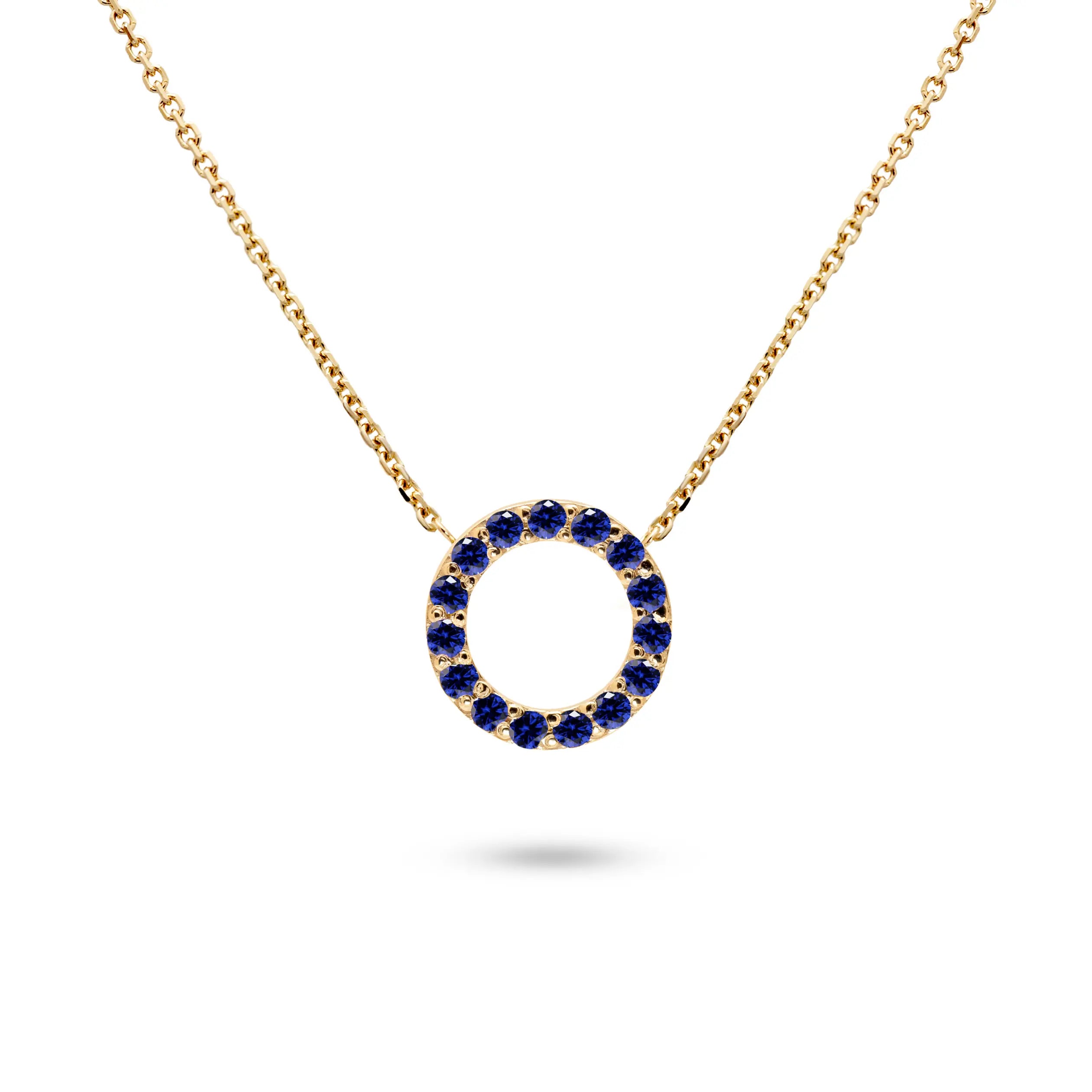 Blue Sapphire Necklace Gold 14K featuring a circular pendant set with blue sapphires and a gold chain.