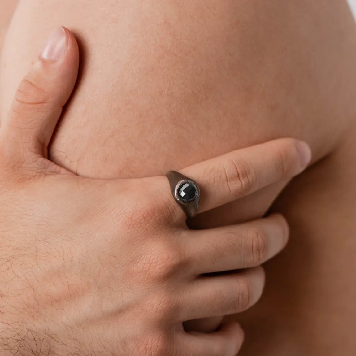 Man wearing Black Onyx Ring Oxidized Silver 925 with handcrafted brutalist design.