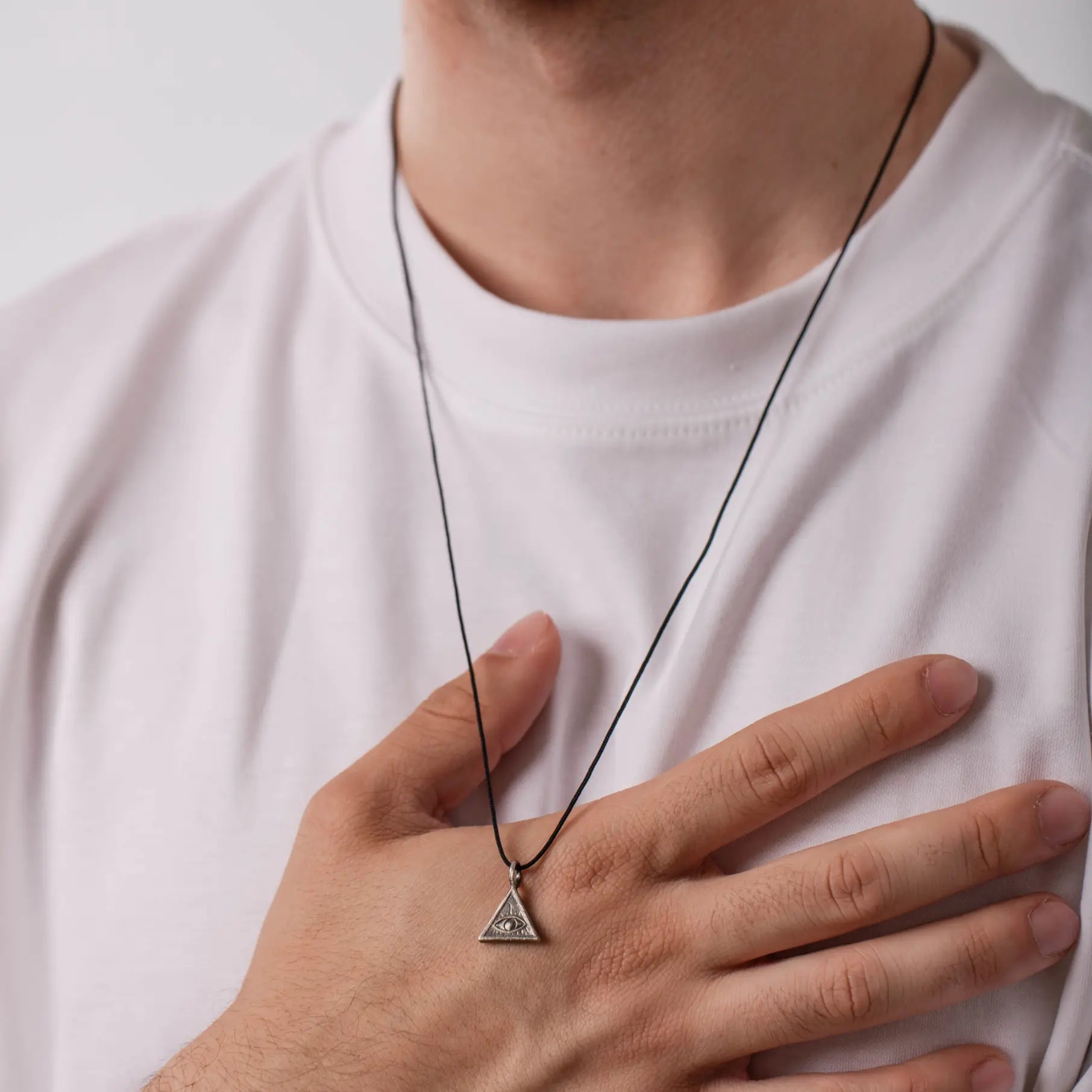 Person wearing Eye of Providence Necklace in oxidized silver with all-seeing eye pendant, symbolizing guidance and protection.