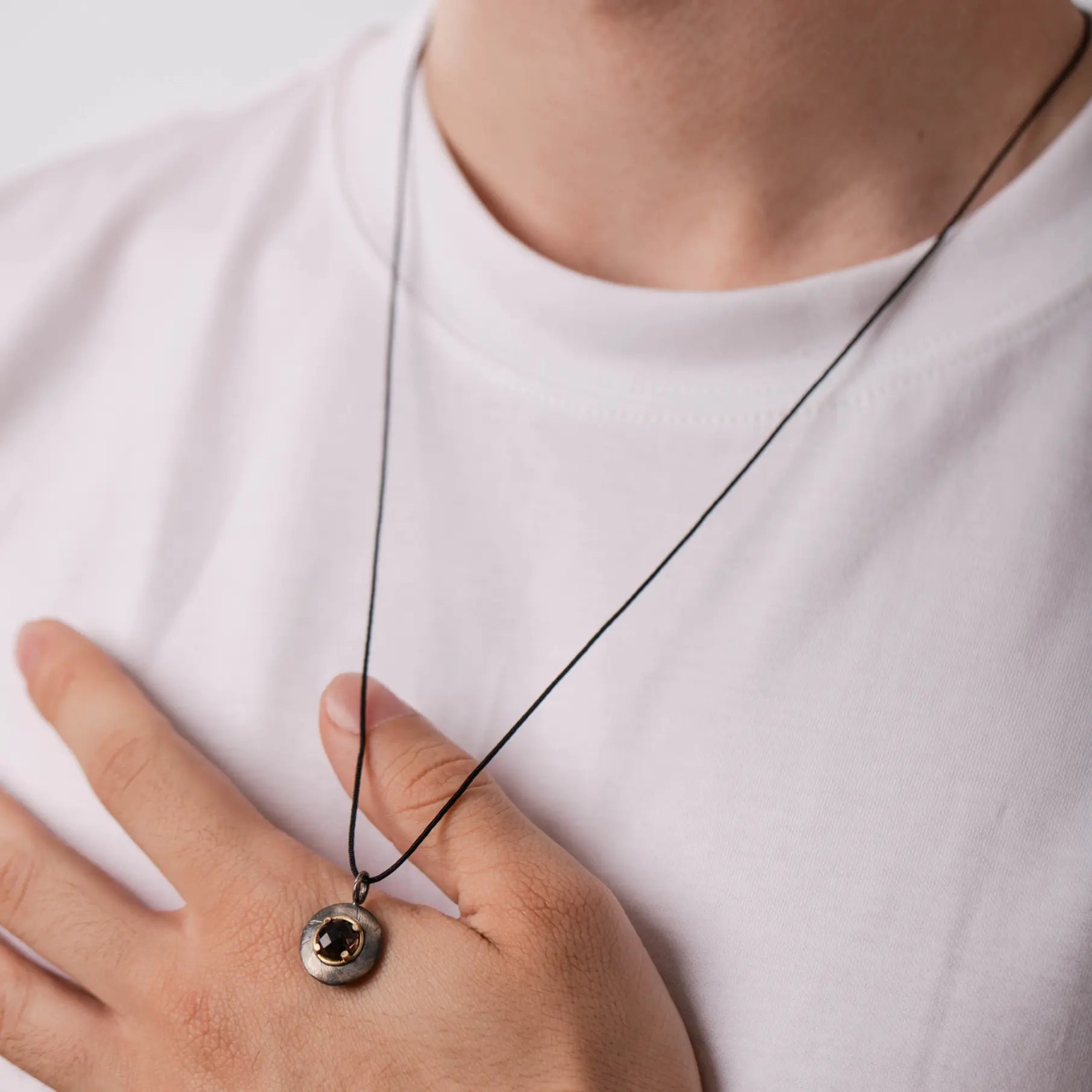 Smoky Quartz Disc Necklace Silver and 14K Gold pendant worn on a person, featuring a natural smoky quartz on oxidized silver and gold.
