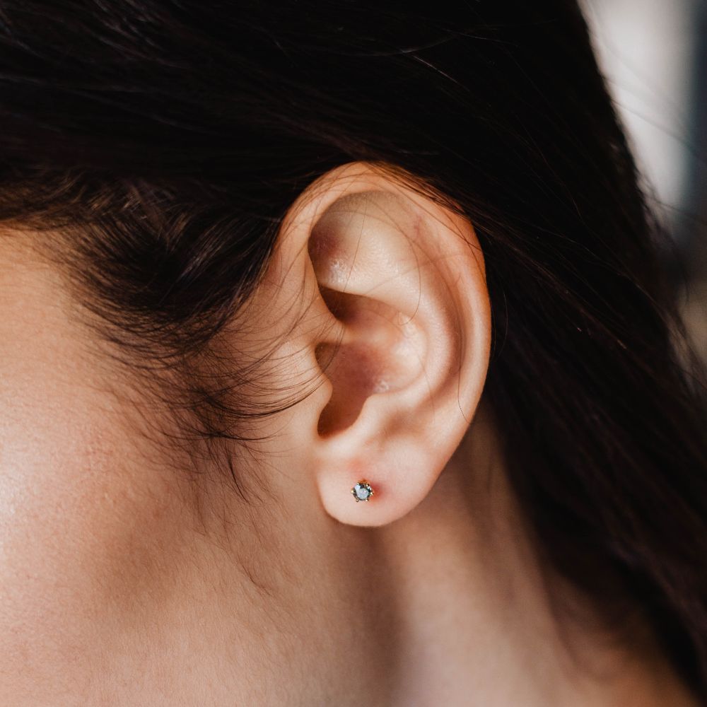 Gray Diamond Stud Earrings in 14K Gold displayed on ear, handcrafted elegant jewelry.