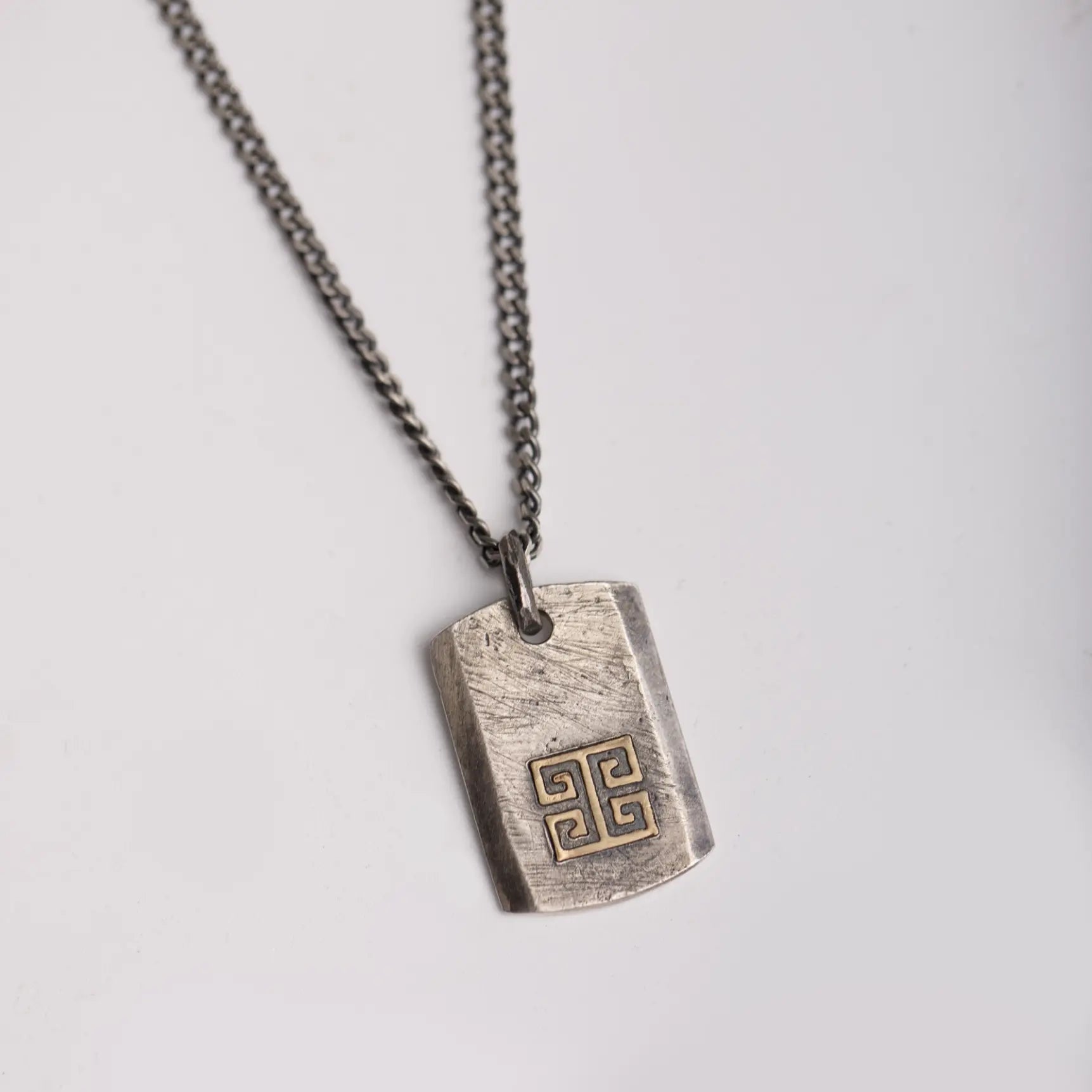 Greek Key Necklace Oxidized Silver 14K Gold pendant with meander pattern on chain.