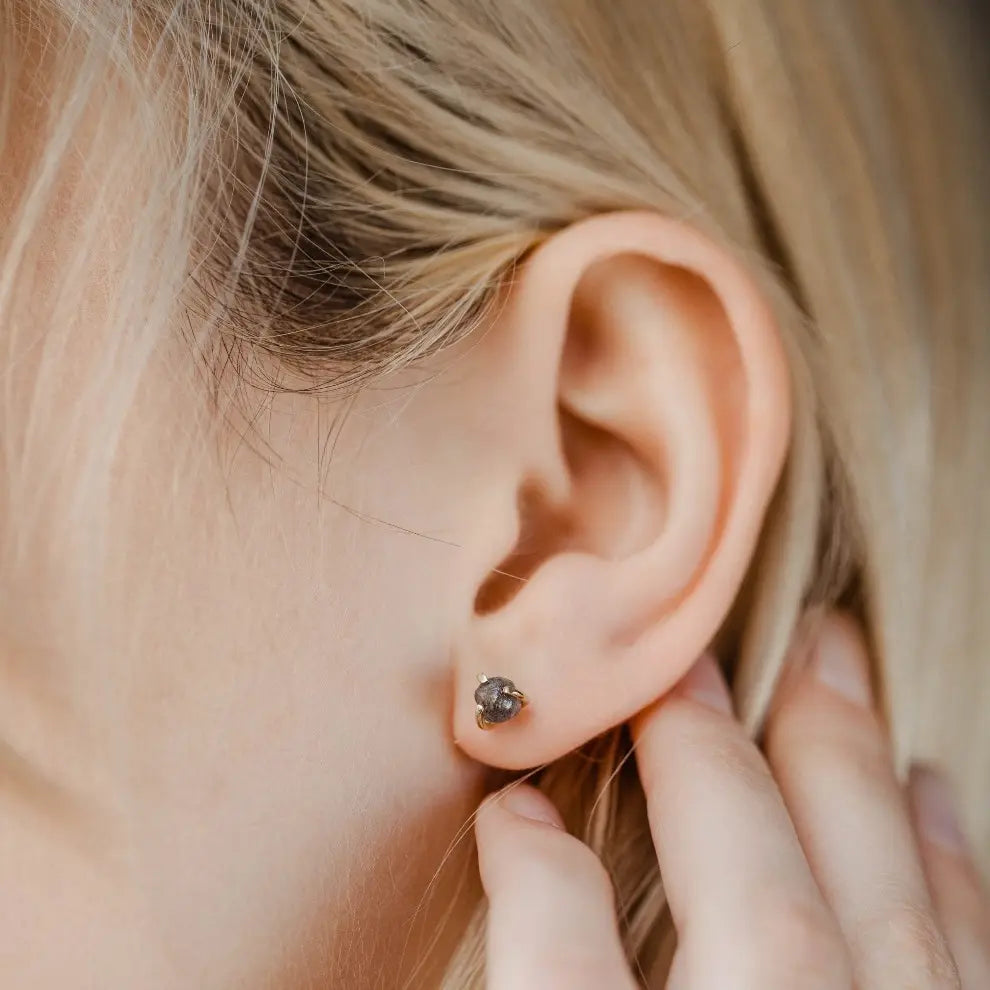 Woman wearing Grey Diamond Studs 14K Gold earrings, featuring handmade design with 5mm grey diamonds and 2.03ct weight.