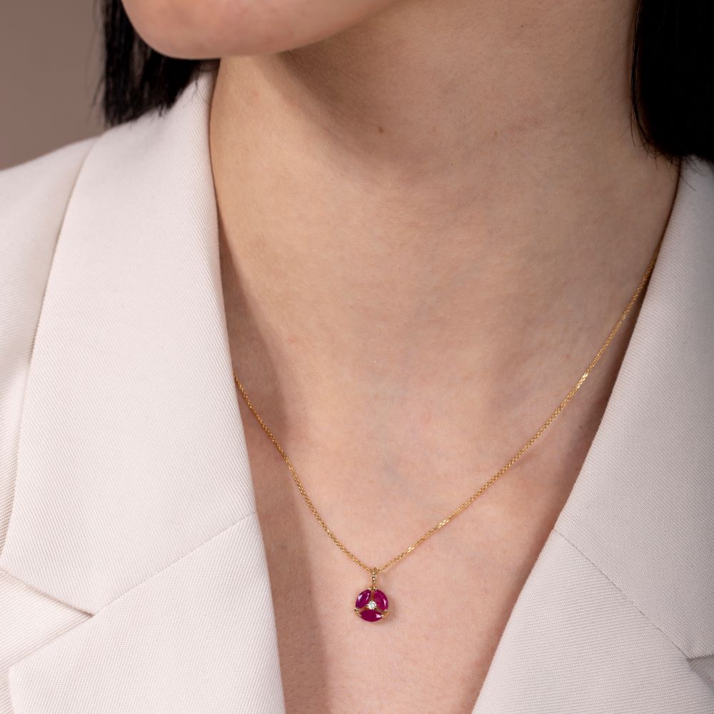 Ruby Diamond Necklace 14K Gold flower pendant on model, showcasing natural marquise ruby and diamond on 14K gold chain, close-up view