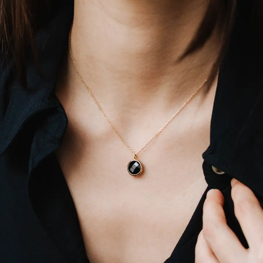 Black Onyx Necklace in 14K Gold worn around neck, close-up view