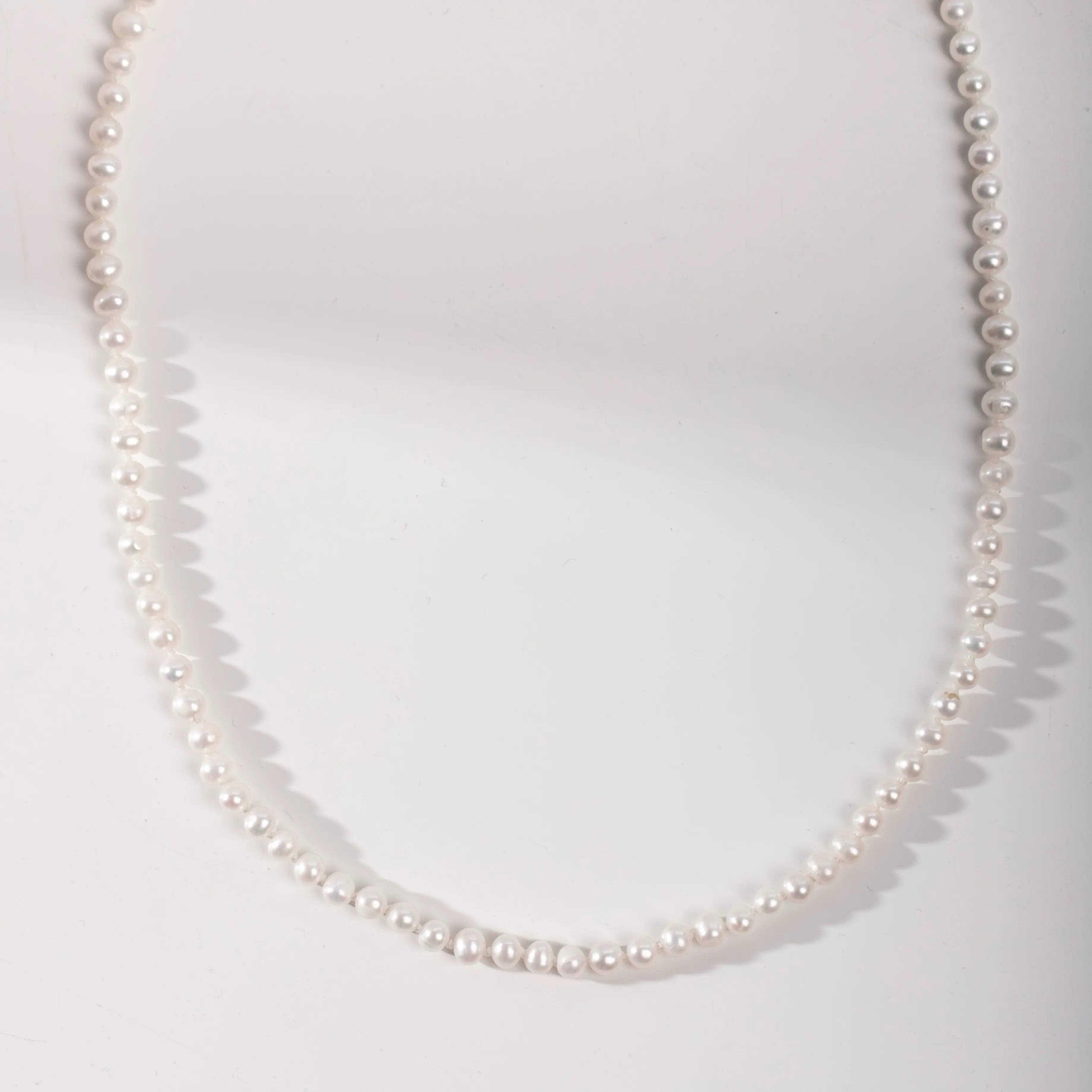 14K Gold Pearl Necklace with natural freshwater pearls, 16 inches long, featuring elegant solid gold clasp, perfect gift in stylish package.