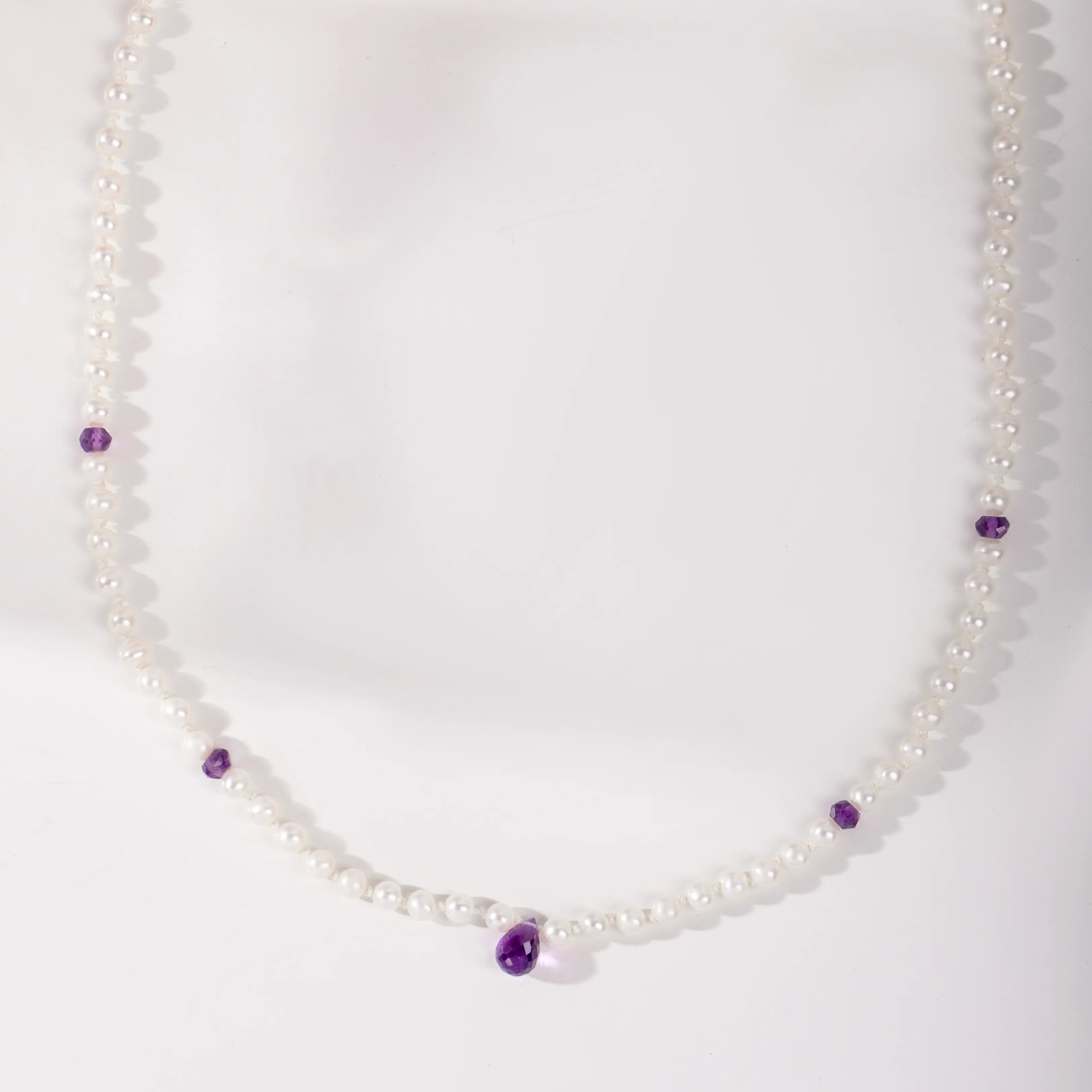 14K Gold Pearl Necklace with Amethyst featuring freshwater pearls and purple gemstones on white background.