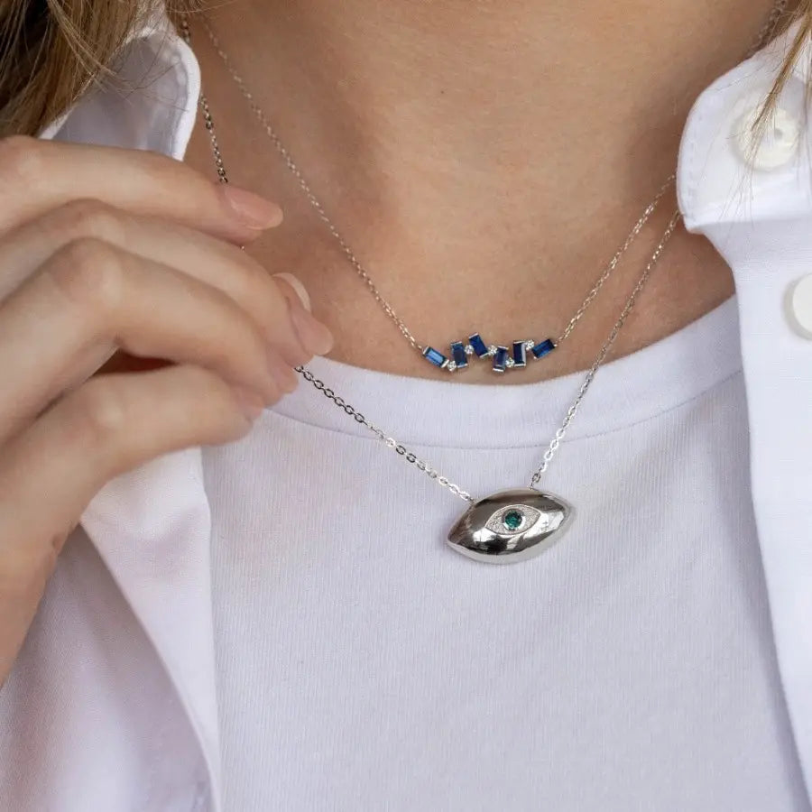 Person wearing Evil Eye Necklace 14K Gold Blue Diamond, featuring protective evil eye design with a blue diamond centerpiece.