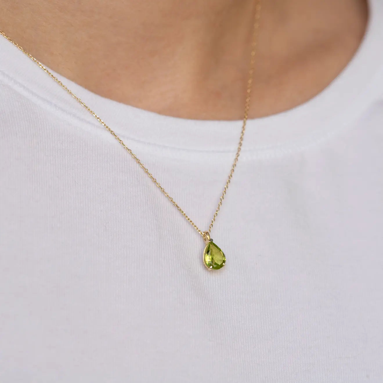 Peridot Necklace 14K Gold Pear Cut showcased on model's neck