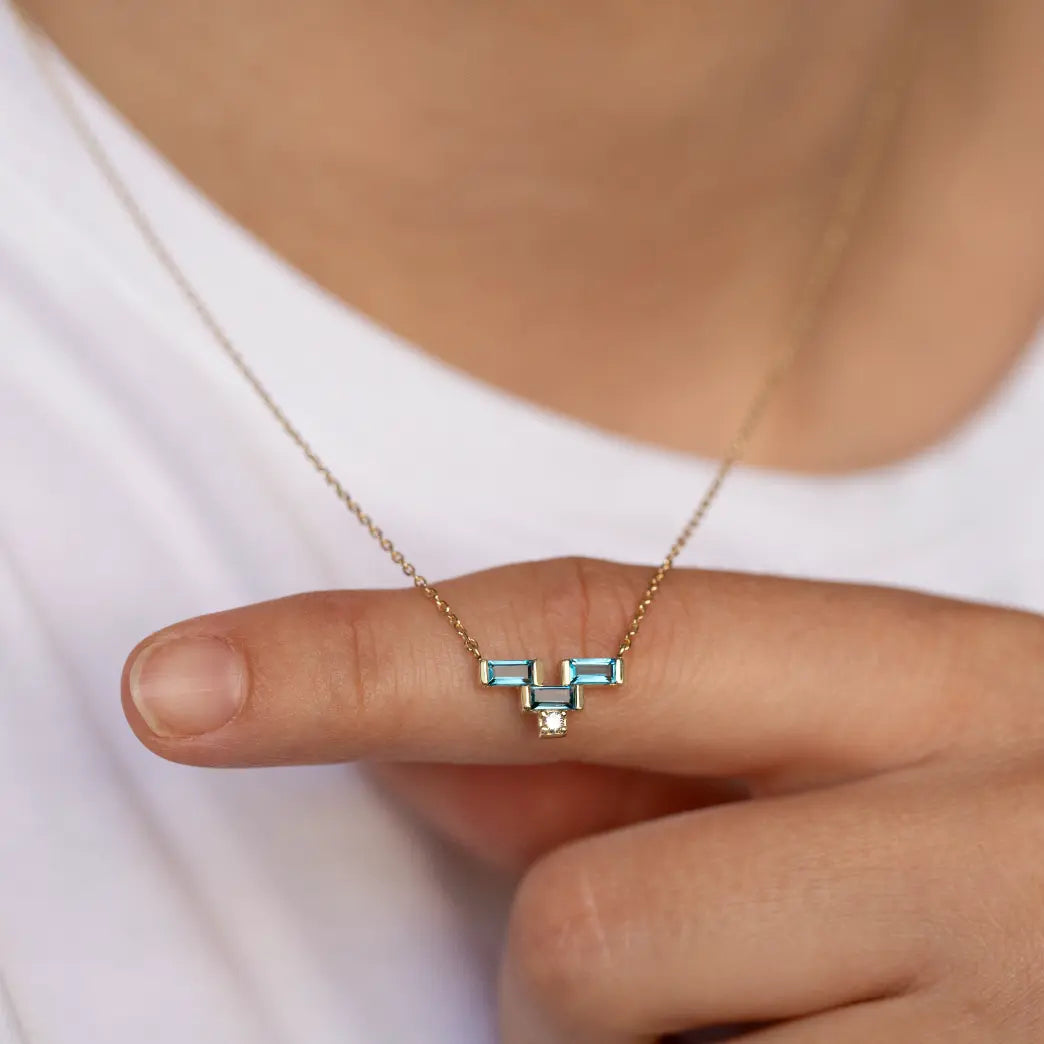 Elegant Blue Topaz Baguette Diamond Necklace 14K Gold featuring London blue topaz and diamonds in geometric design on a delicate chain.