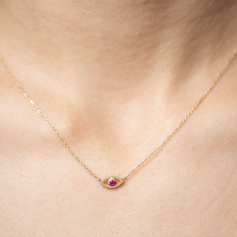 Ruby eye necklace 14K gold featuring a red ruby stone on a delicate gold chain, perfect gift jewelry displayed on model's neck.