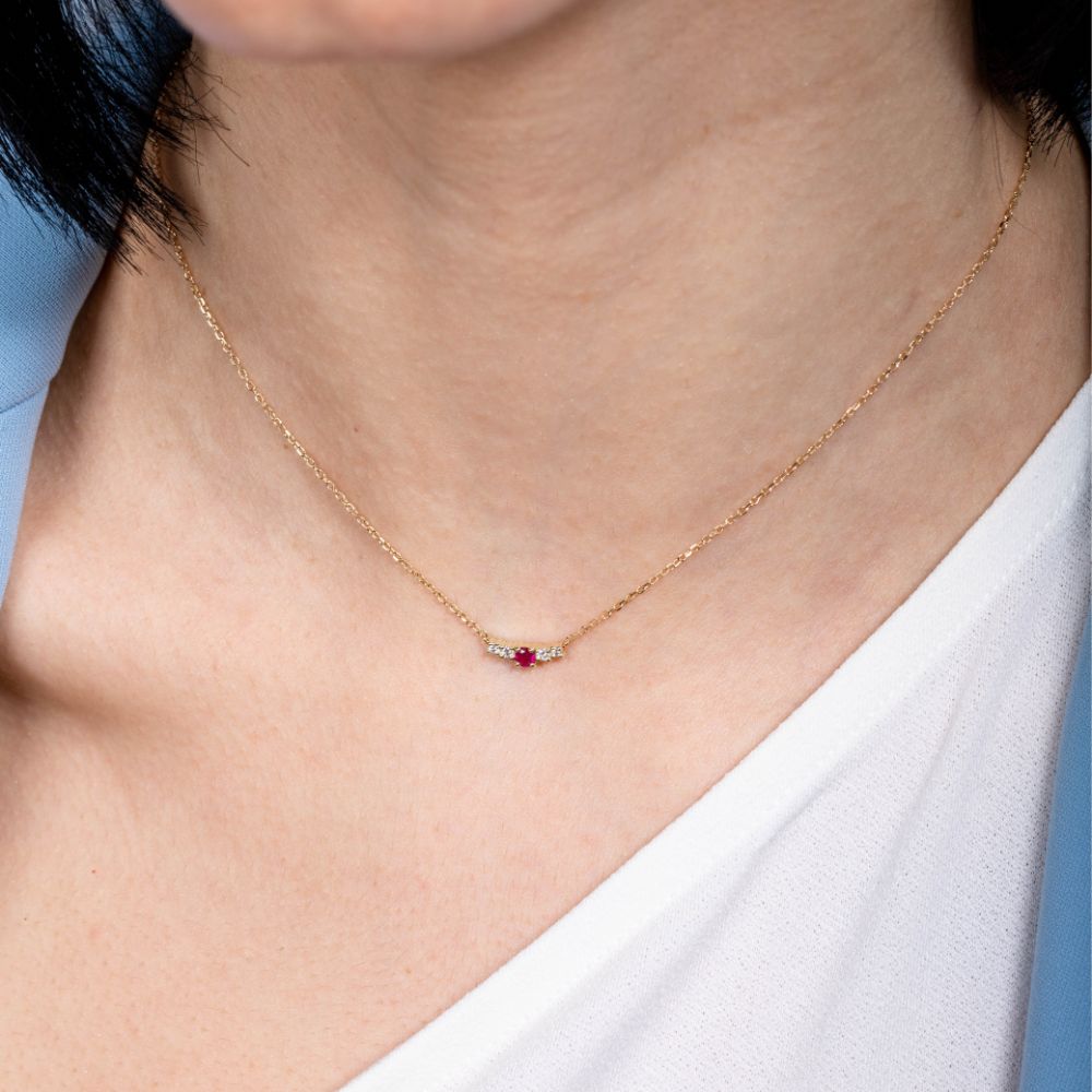 Woman wearing Ruby Diamond Necklace 14K Gold with round and brilliant cut gemstones, perfect gift choice.