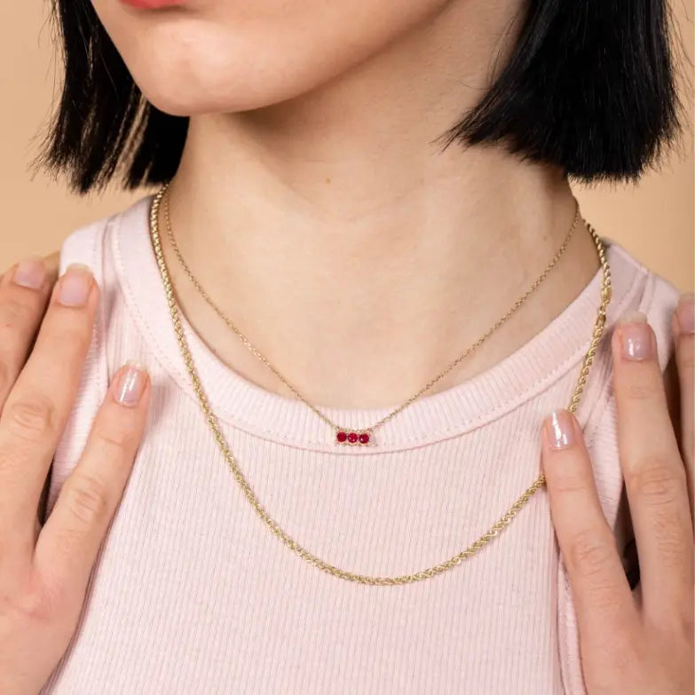 Model wearing a Ruby Necklace 14K Gold with 3mm rubies on a 40cm chain.