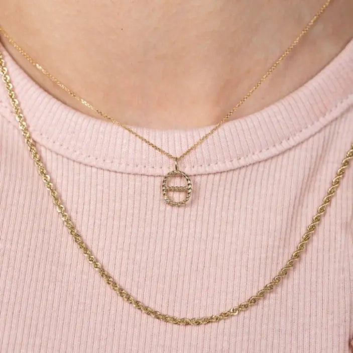 Greek Letter Necklace with diamond 14K gold on pink fabric, featuring monogram, brilliant cut diamond, conflict-free, authentic packaging