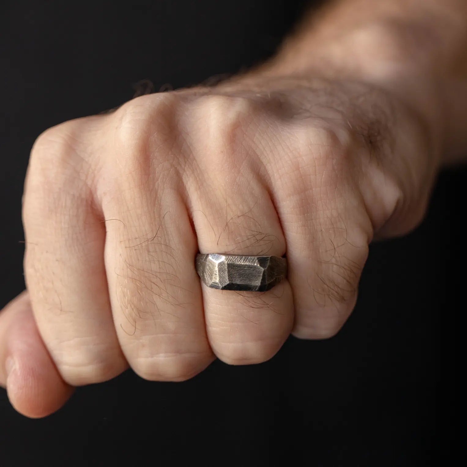 Rectangle Ring Oxidized Silver 925 on male hand, brutalist style, 8mm wide handcrafted sterling silver with faceted black oxidized finish.