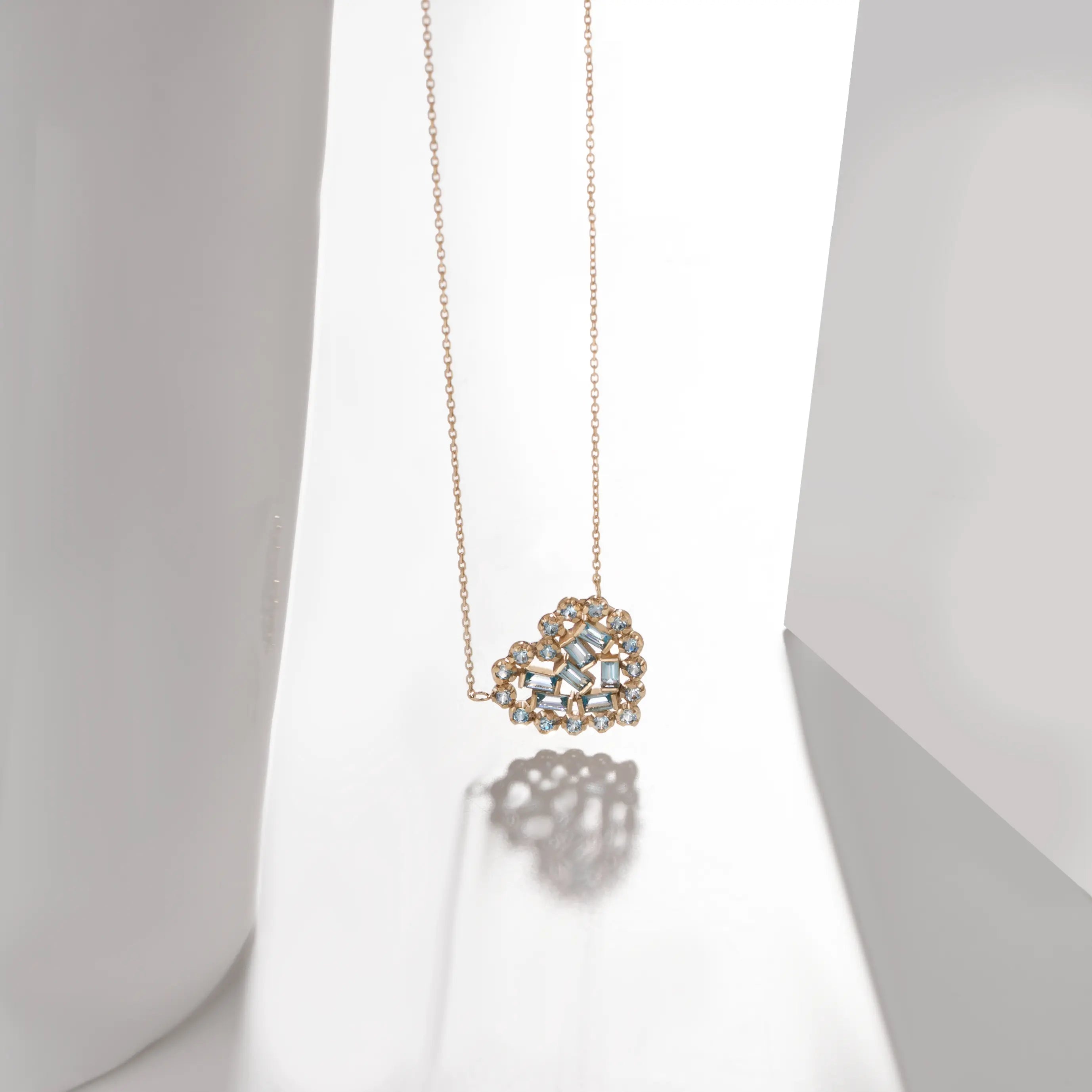 Swiss Blue Topaz Heart Necklace 14K in solid gold with heart-shaped design, featuring baguette and round cut gemstones for a unique gift.