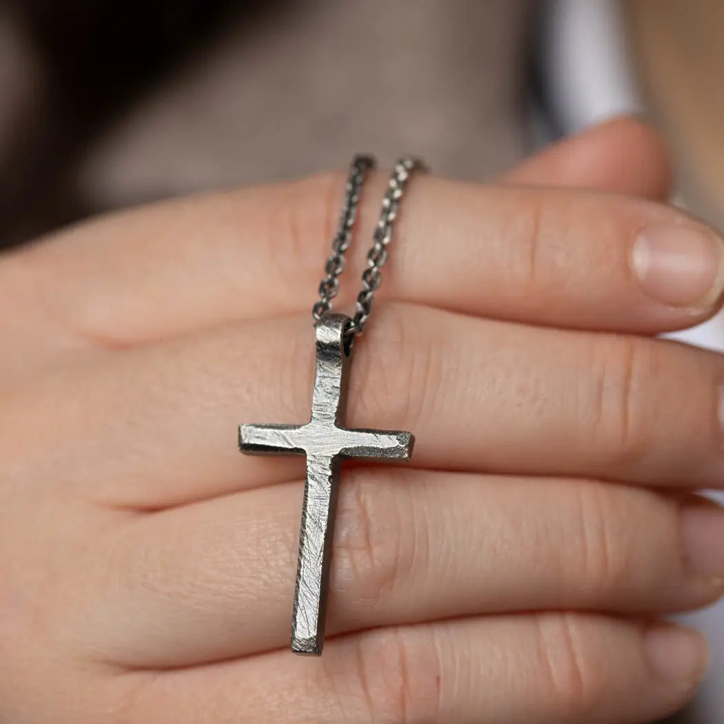 Cross Necklace Men Oxidized Silver displayed in a hand, featuring a striking oxidized silver cross pendant.