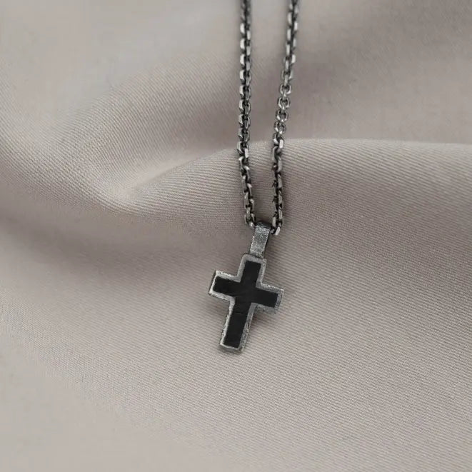 Silver Cross Necklace Black Enamel on fabric background