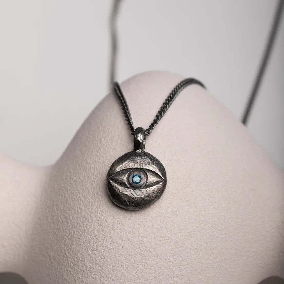 Evil Eye Necklace Oxidized Silver London Blue Topaz on display