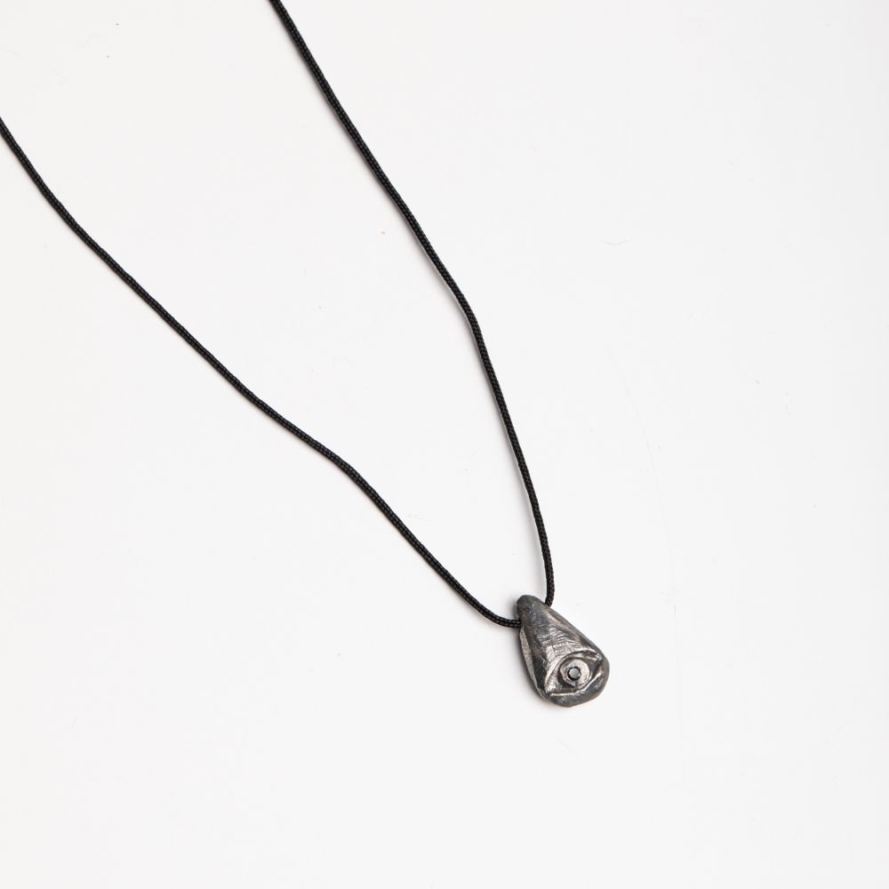 Oxidized silver evil eye necklace with black diamond pendant on white background, handcrafted for men, in black oxidized sterling silver.