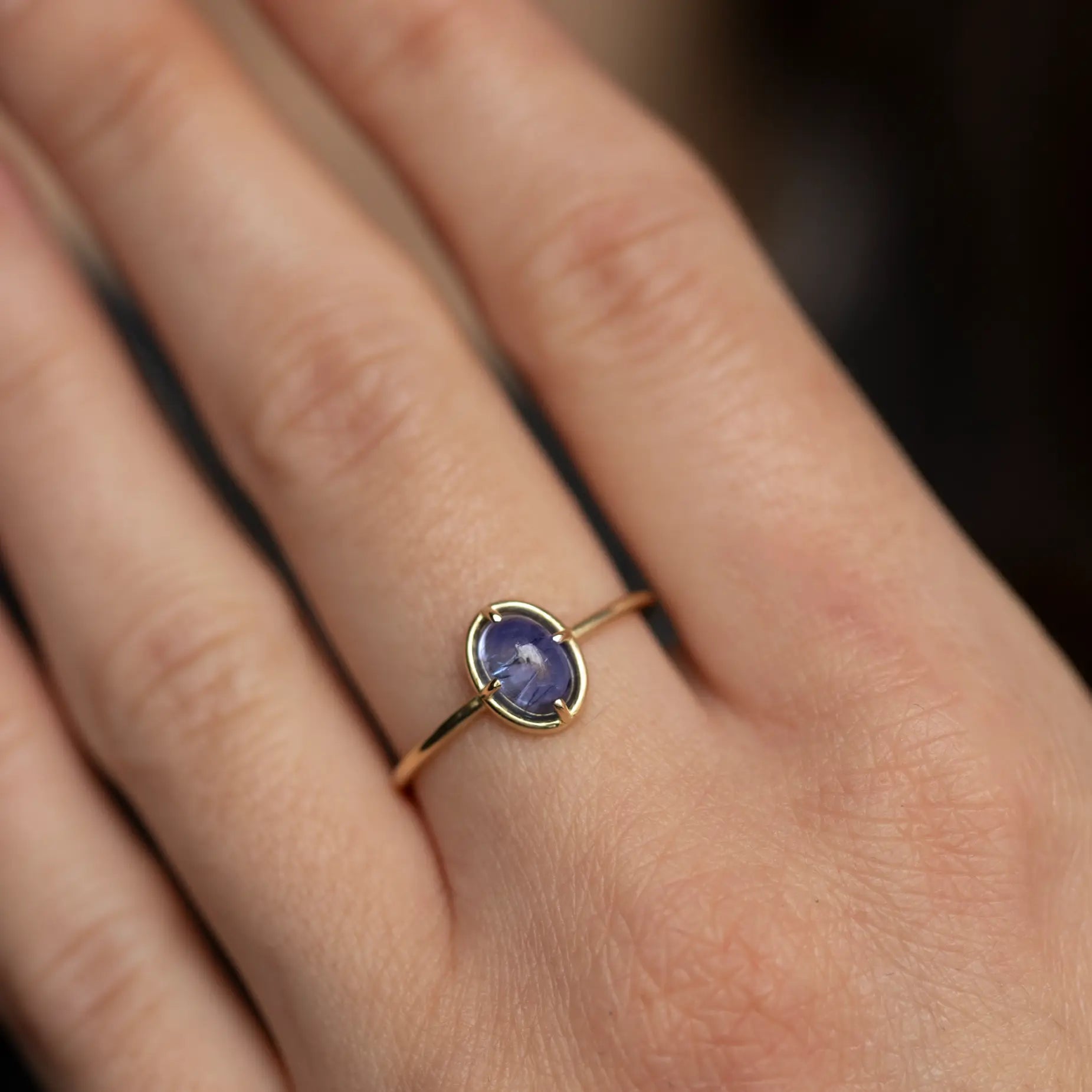 Oval Tanzanite Solitaire Ring 14K Gold on hand, natural 1.10ct tanzanite gemstone, handmade, elegant, with certificate of authenticity.