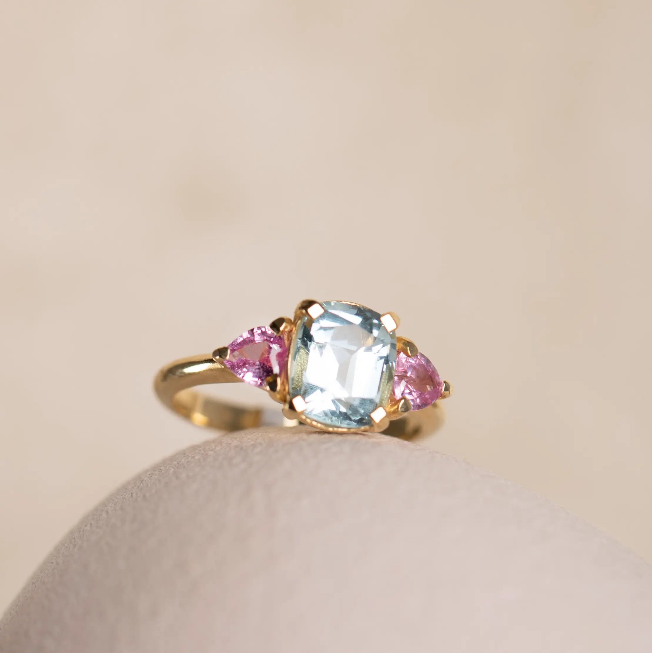Aquamarine Pink Heart Sapphire Engagement Ring 18K with aquamarine center stone and pink sapphire accents on a gold band.