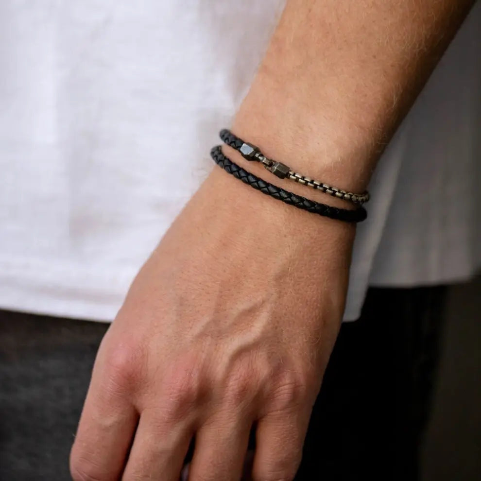Men Leather Cord Wrap Bracelet Oxidized Silver on wrist, featuring black leather and oxidized sterling silver chain with handmade hook closure.