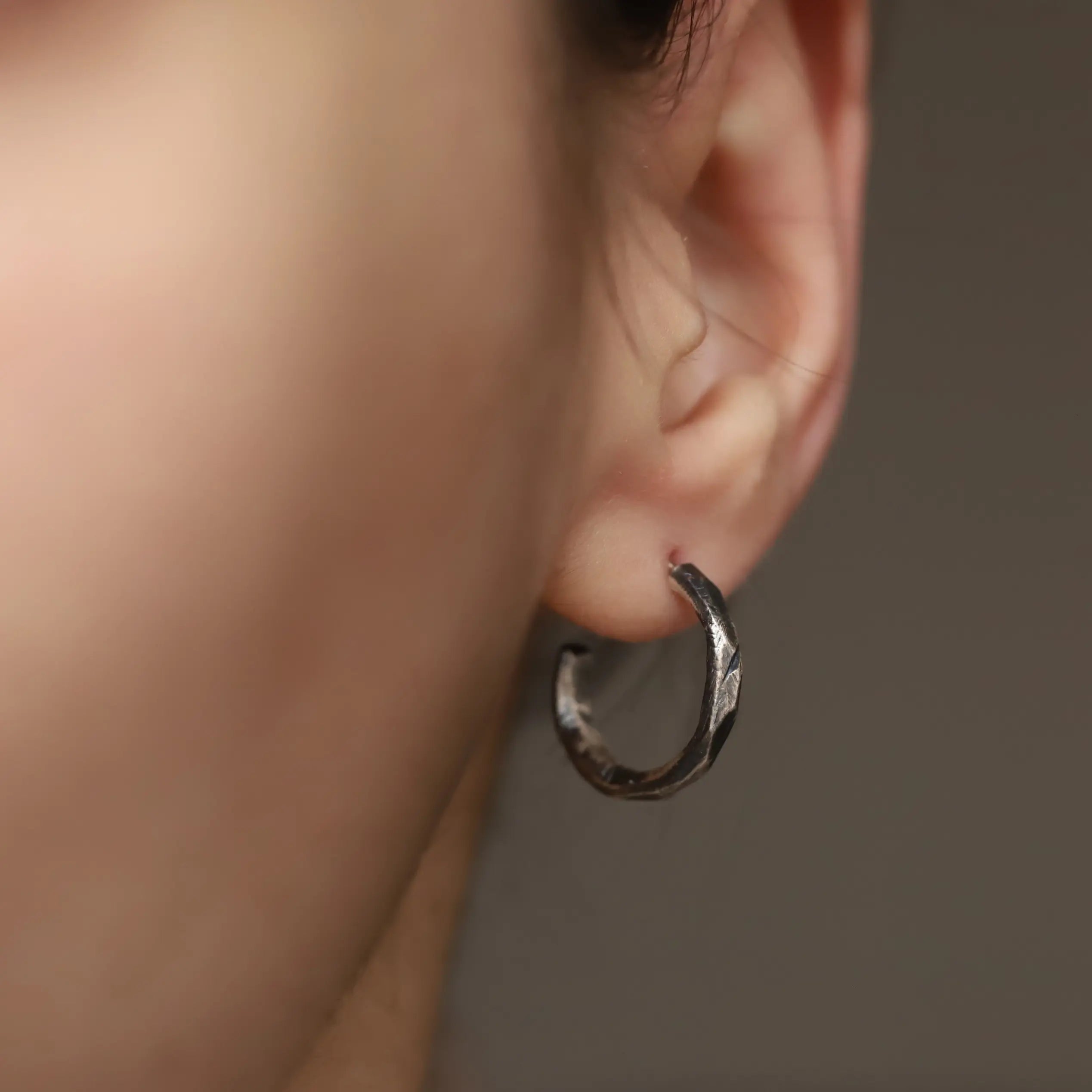 Faceted Hoop Earrings Oxidized Silver worn by a model, handmade sterling silver, 17mm diameter, 2mm width, eco leather pouch included.