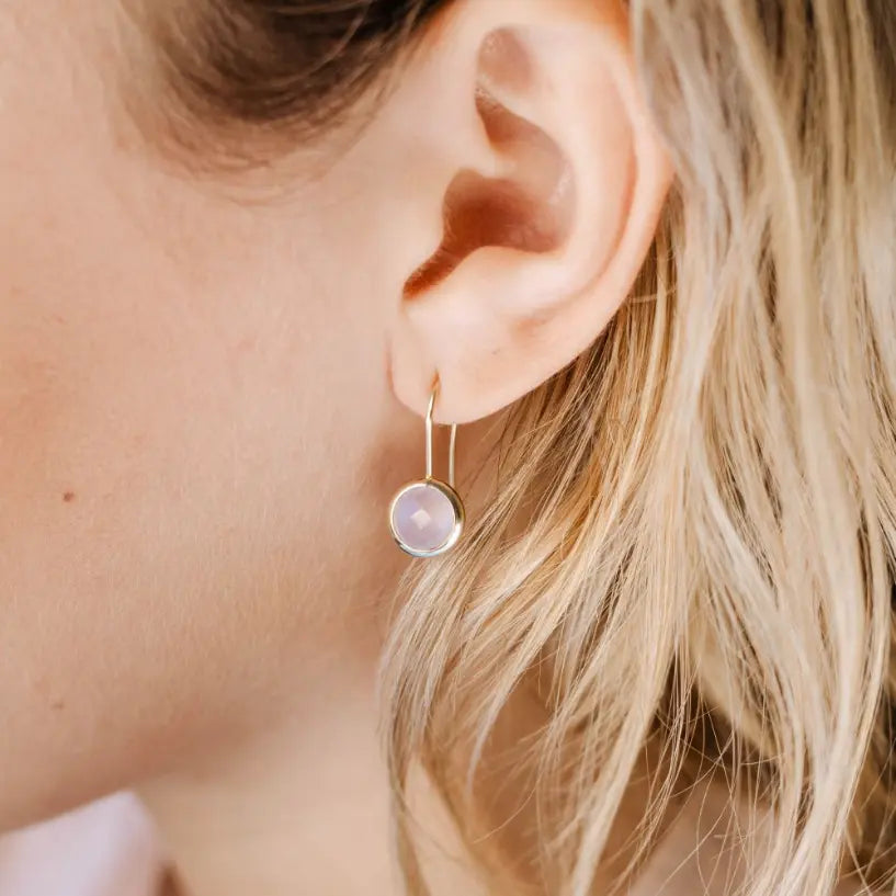 Woman wearing handcrafted 10mm Rose Quartz Earrings in 14K gold, highlighting elegance and simplicity.