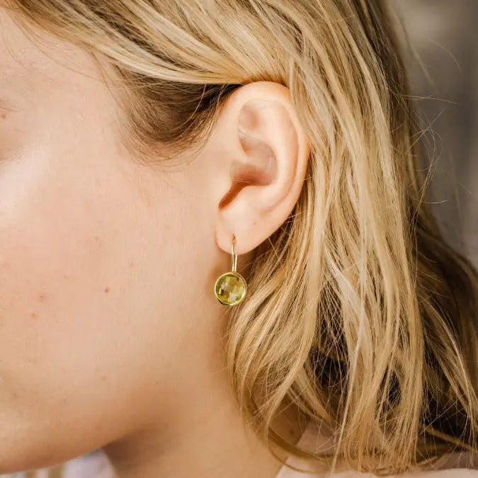 Close-up of 10mm Lemon Quartz Earrings in 14K Gold worn by a model, highlighting the gemstone's elegance and handcrafted design.