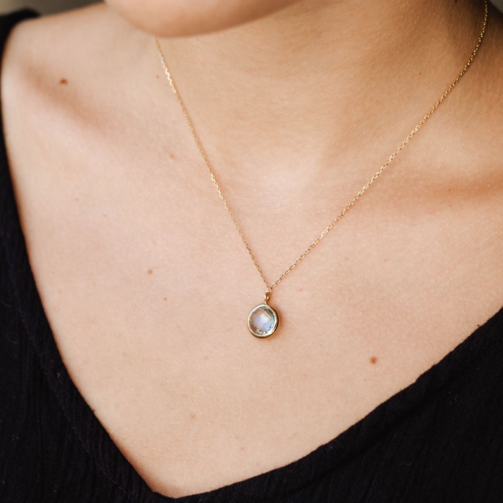 Blue Topaz Necklace in 14K Gold on a woman's neck, elegant briolette jewelry in rose, white, or yellow gold setting.
