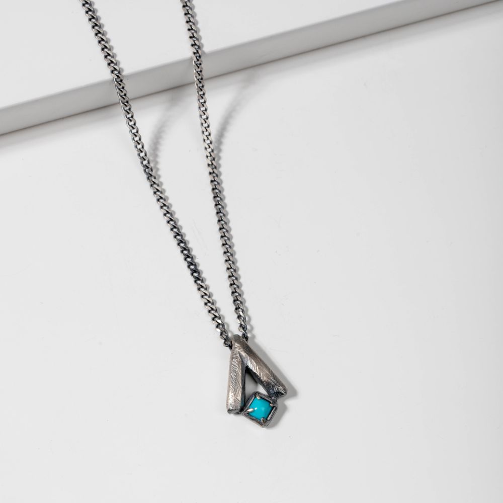 Oxidized Silver Turquoise Necklace with brutalist V pendant on sterling silver curb chain, featuring natural turquoise, nickel free.