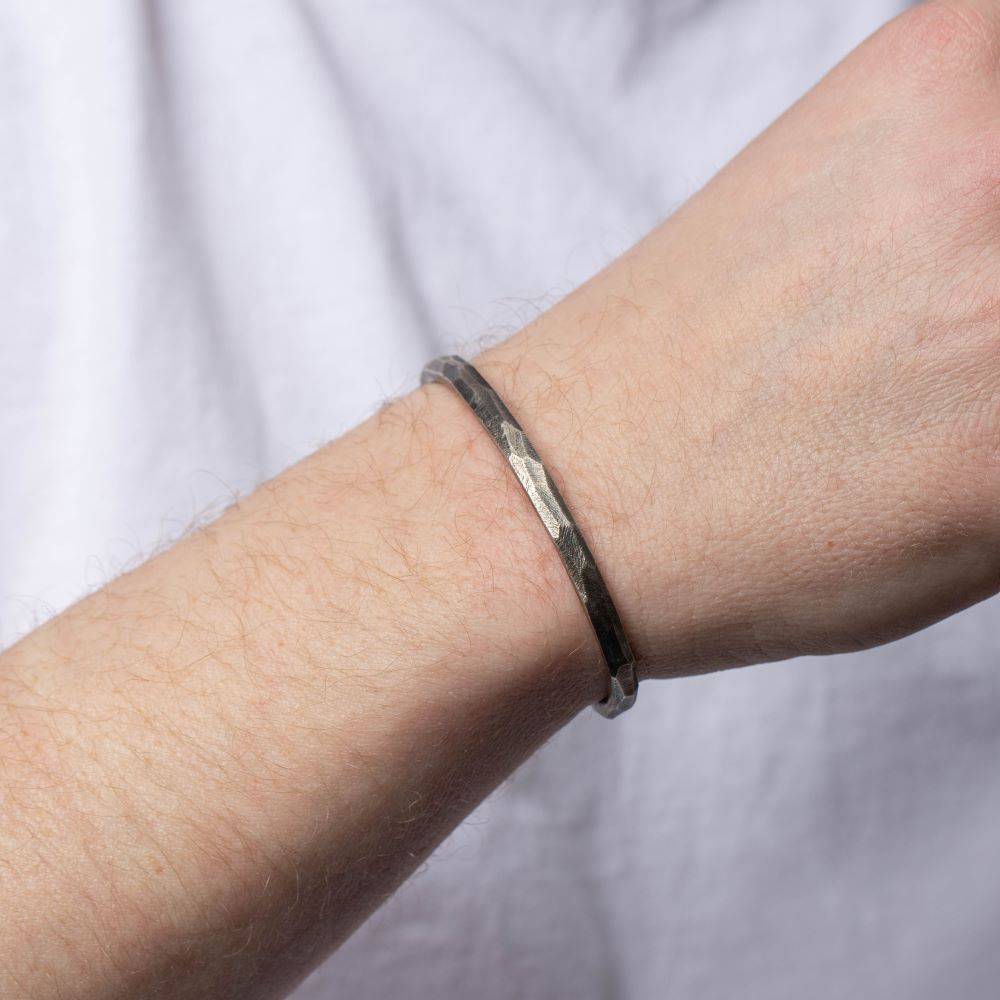 Faceted Cuff Bracelet Oxidized Silver, handmade unisex streetwear jewelry in black oxidized sterling silver, worn on wrist, 5mm width.