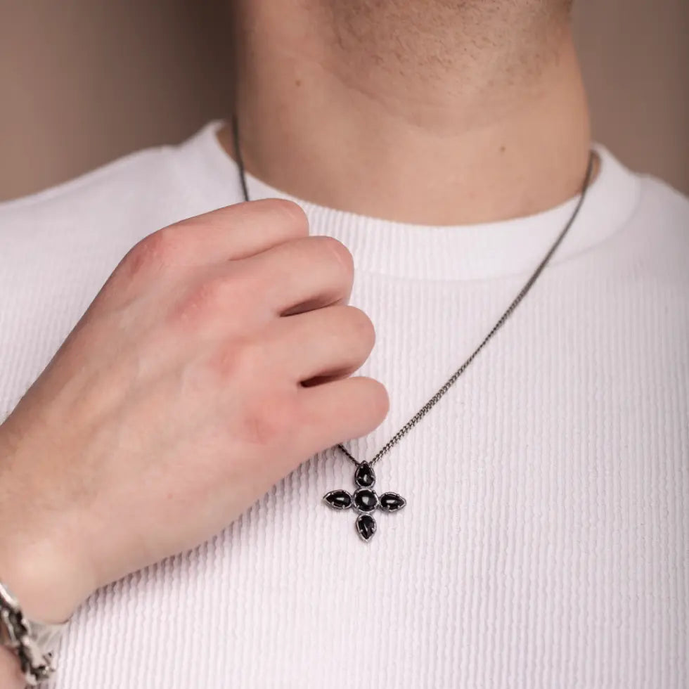 Man wearing Large Cross Necklace Black Onyx Oxidized Silver with a brutalist style design, featuring sterling silver and onyx gemstones.