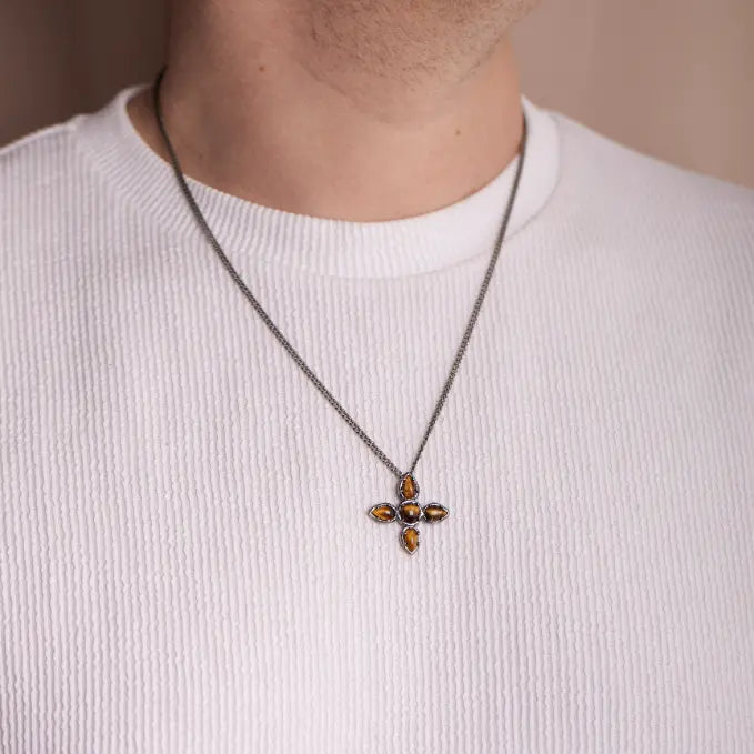 Large Cross Necklace Tiger Eye Oxidized Silver with sterling silver chain on person wearing white shirt.