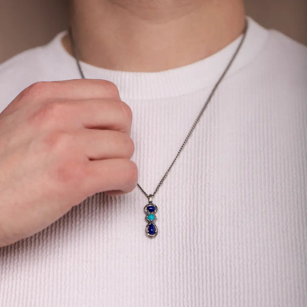 Lapis Lazuli and Turquoise Necklace Oxidized Silver on person wearing a white shirt. Sterling silver with natural blue stones.