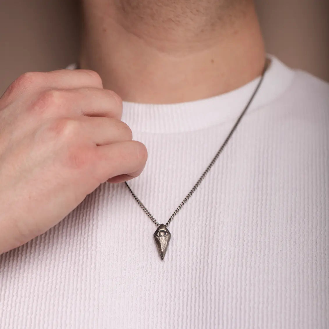 Man wearing Evil Eye Necklace 925 Oxidized Silver with handmade pendant on a sterling silver chain.