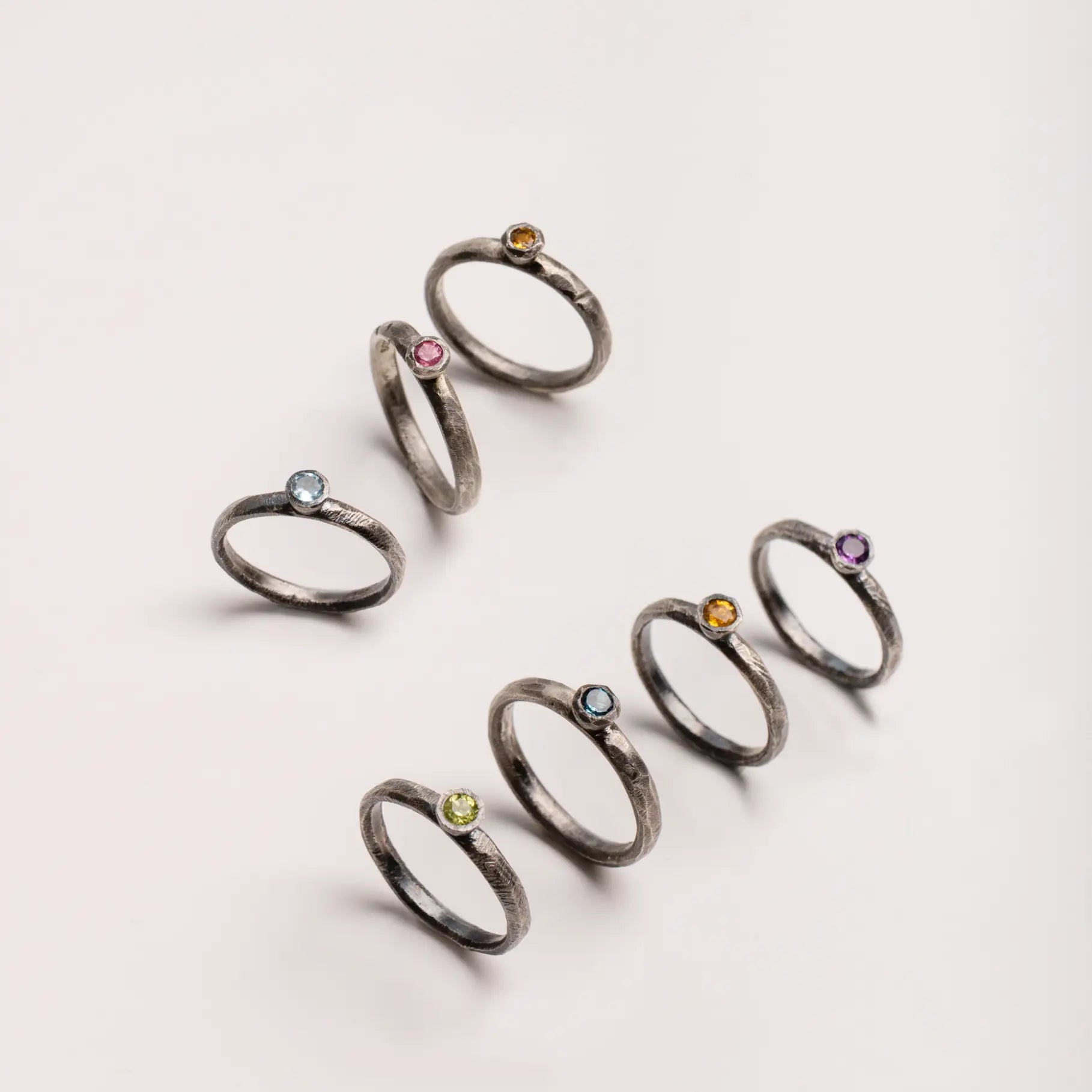 Pink Tourmaline Ring Oxidized Silver 925 collection with gemstone variations on light background.