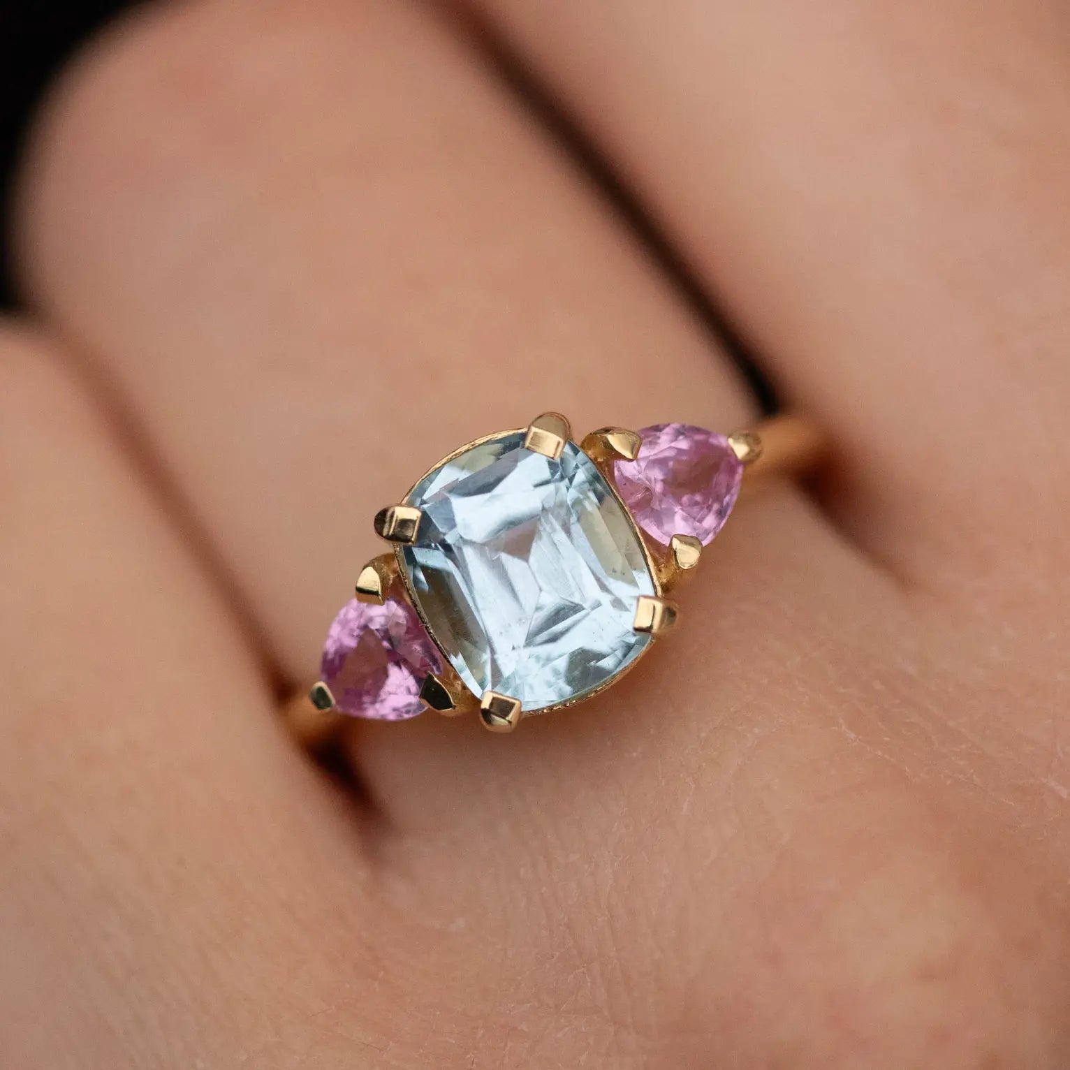 Aquamarine Pink Heart Sapphire Engagement Ring 18K in solid gold with aquamarine center and pink sapphire hearts on hand.