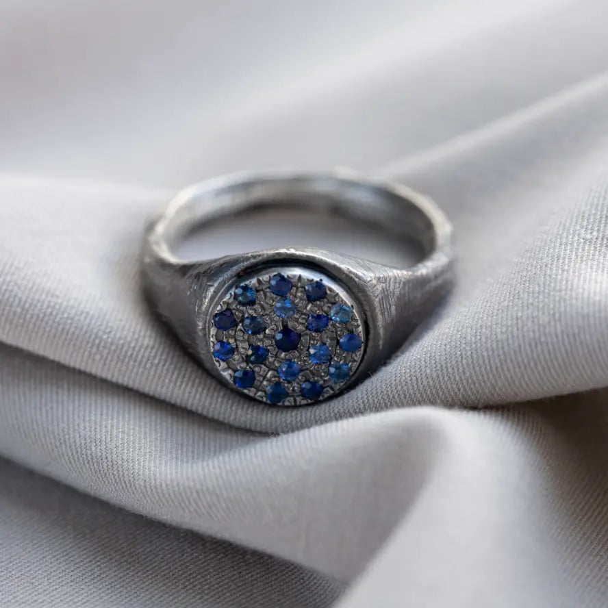 Signet Ring Oxidized Silver 925 Sapphire handcrafted with blue sapphires on a silver fabric, perfect men's gift.
