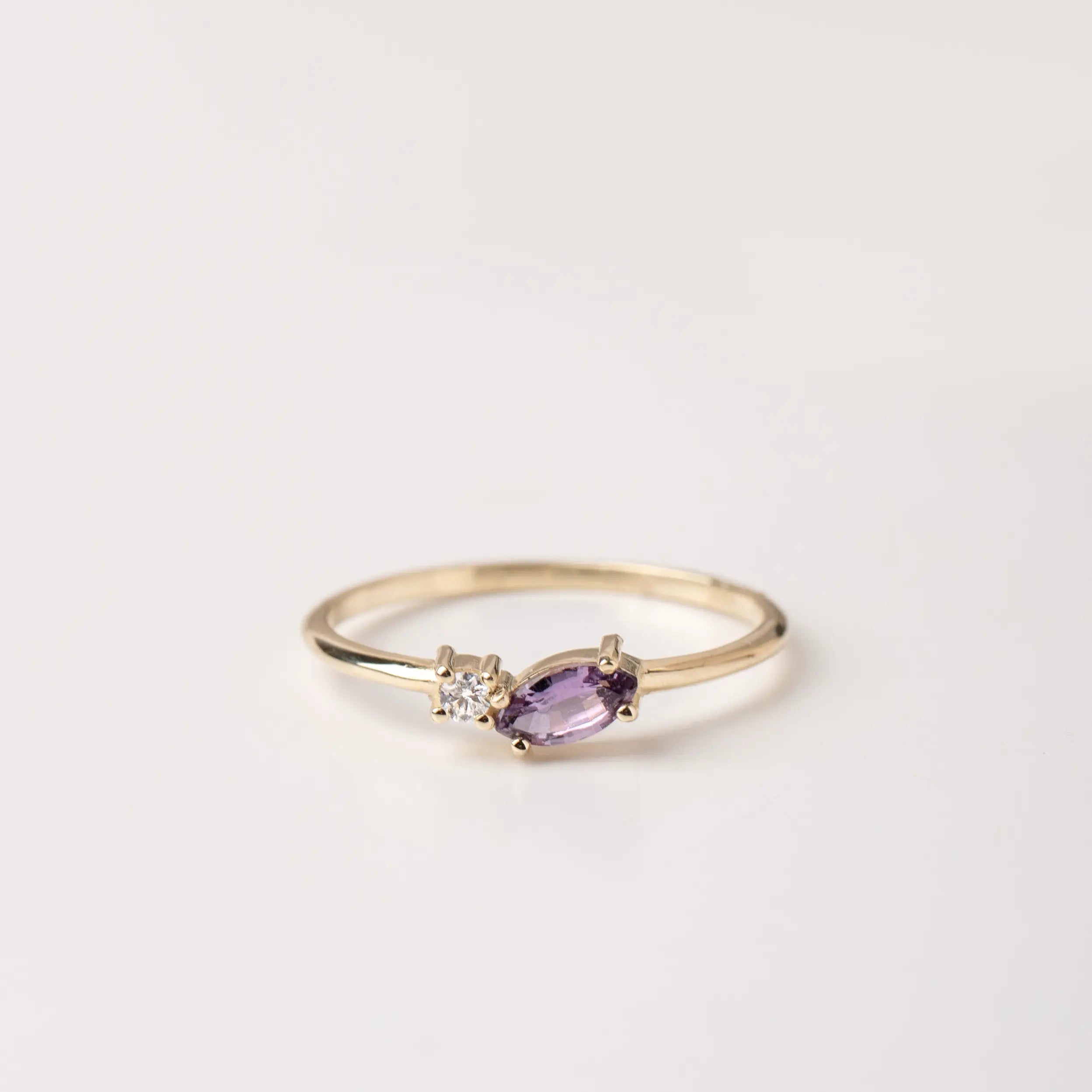 Marquise Pink Sapphire Diamond Ring in 14K gold with marquise cut pink sapphire and brilliant cut diamond, ideal for proposals or gifts.