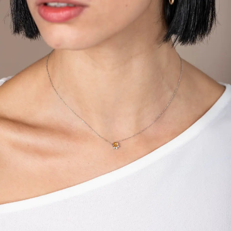Yellow Sapphire Diamonds Necklace 14K on model, featuring a yellow sapphire and three diamonds set in white gold, elegant jewelry piece