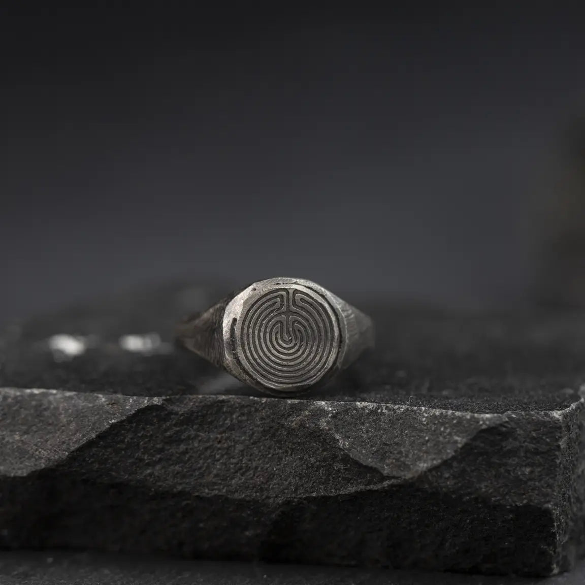 Labyrinth Ring Oxidized Silver 925 on a dark stone surface, showcasing intricate detailing and a bold, masculine design.