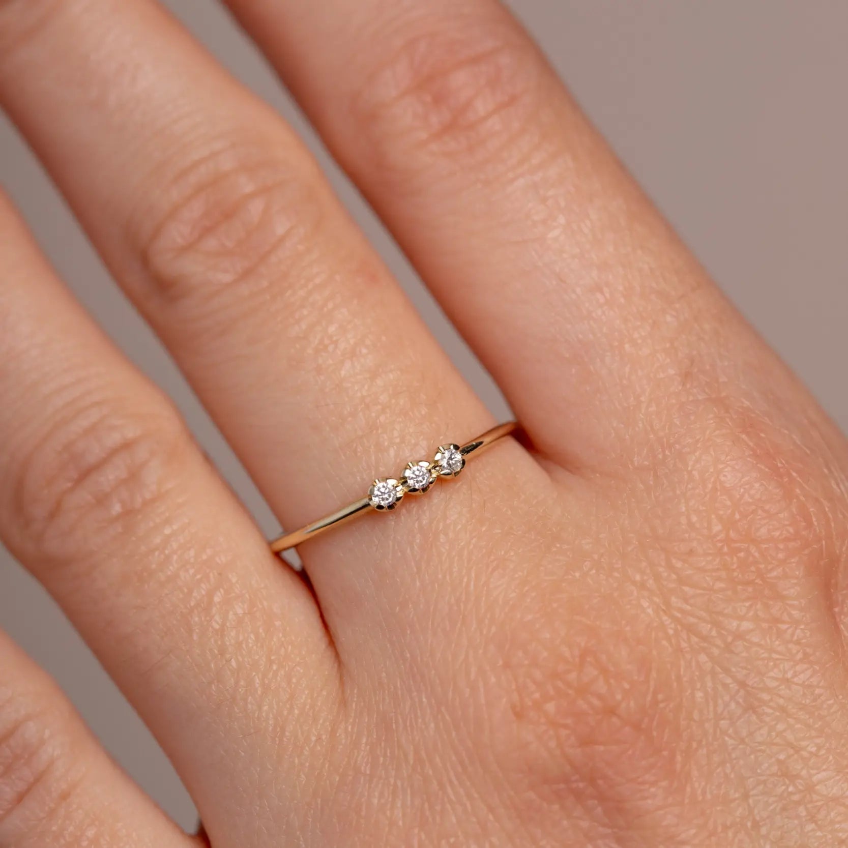 14K Gold 3 Diamonds Ring on woman's finger, featuring a minimalist design with three natural diamonds, perfect for stacking and gifting.