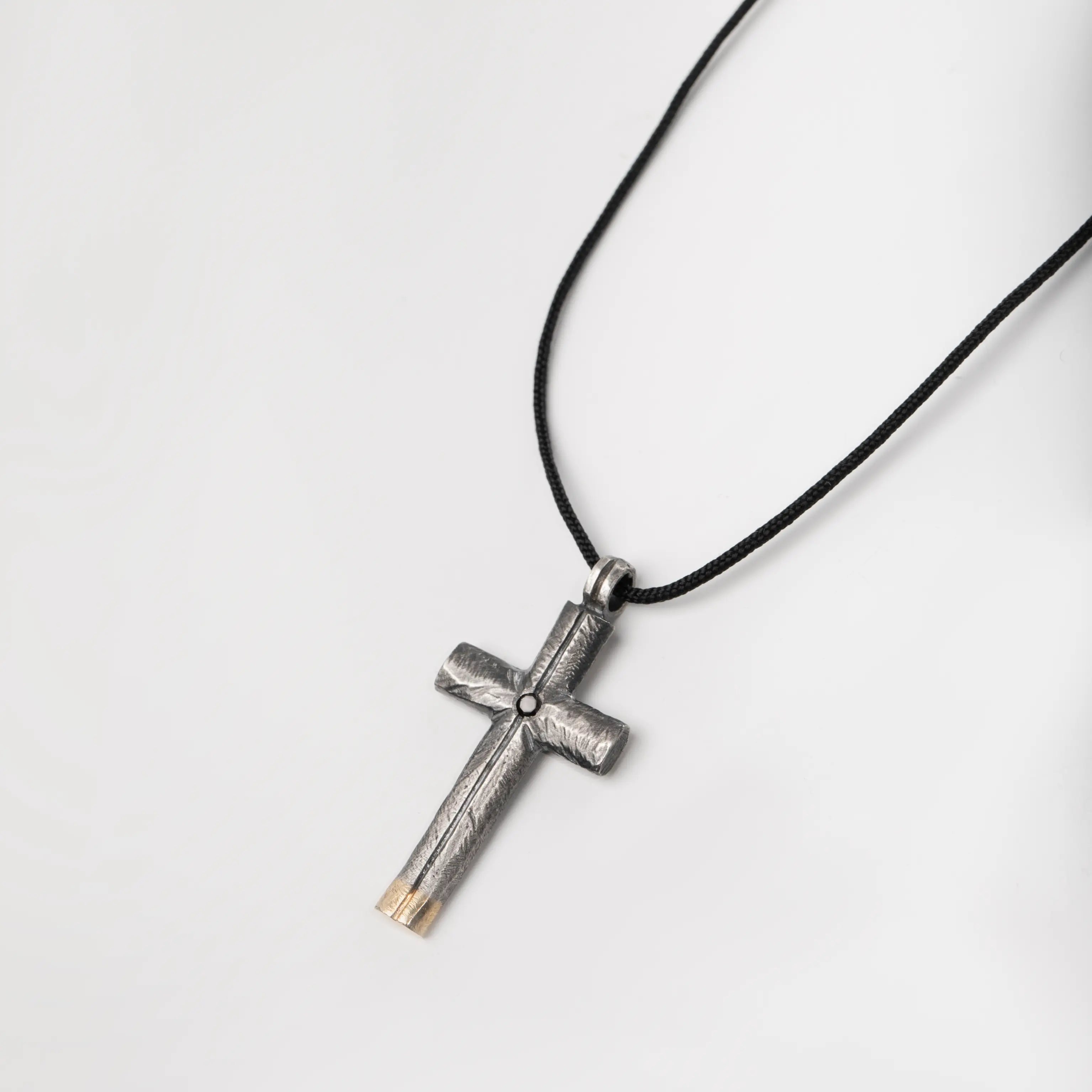 Black diamond cross necklace in oxidized silver and 14K gold pendant on a black cord, ideal gift for men and women.