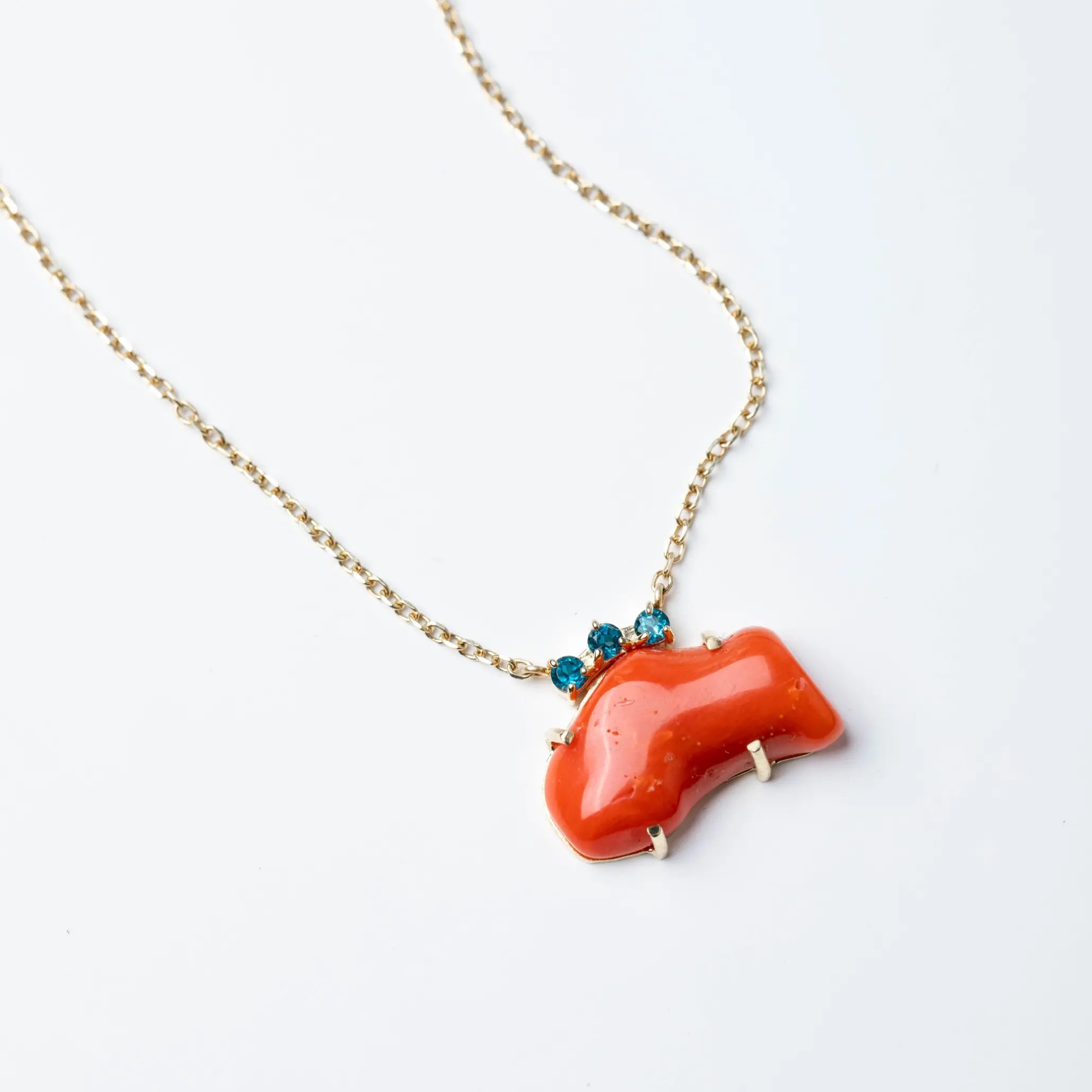 Natural Coral Necklace 14K Gold with Blue Topaz pendant on a delicate gold chain.