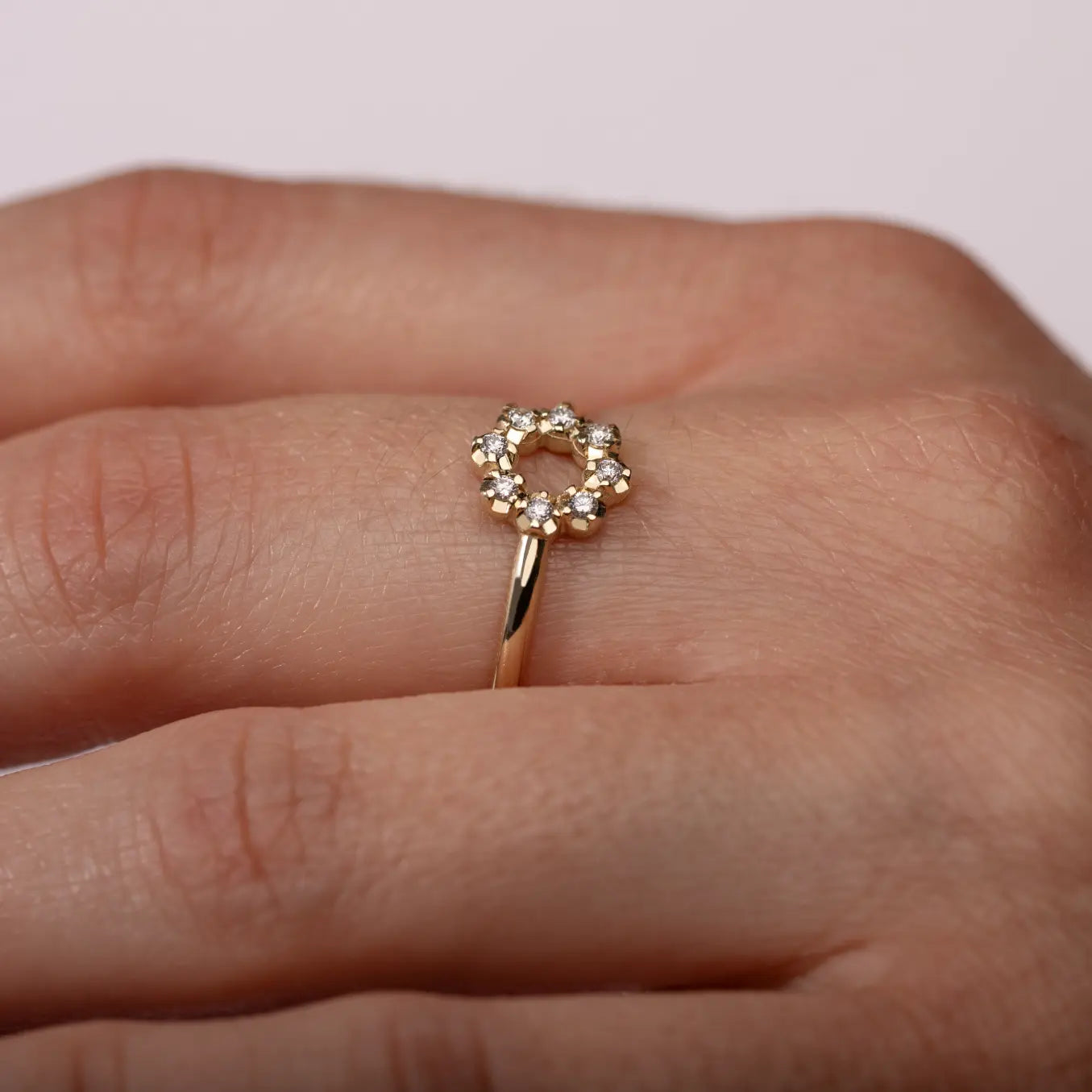 14K Gold Flower Diamond Ring on a woman's hand, showcasing minimalist design with eight sparkling diamonds. Perfect for stacking and gifting.