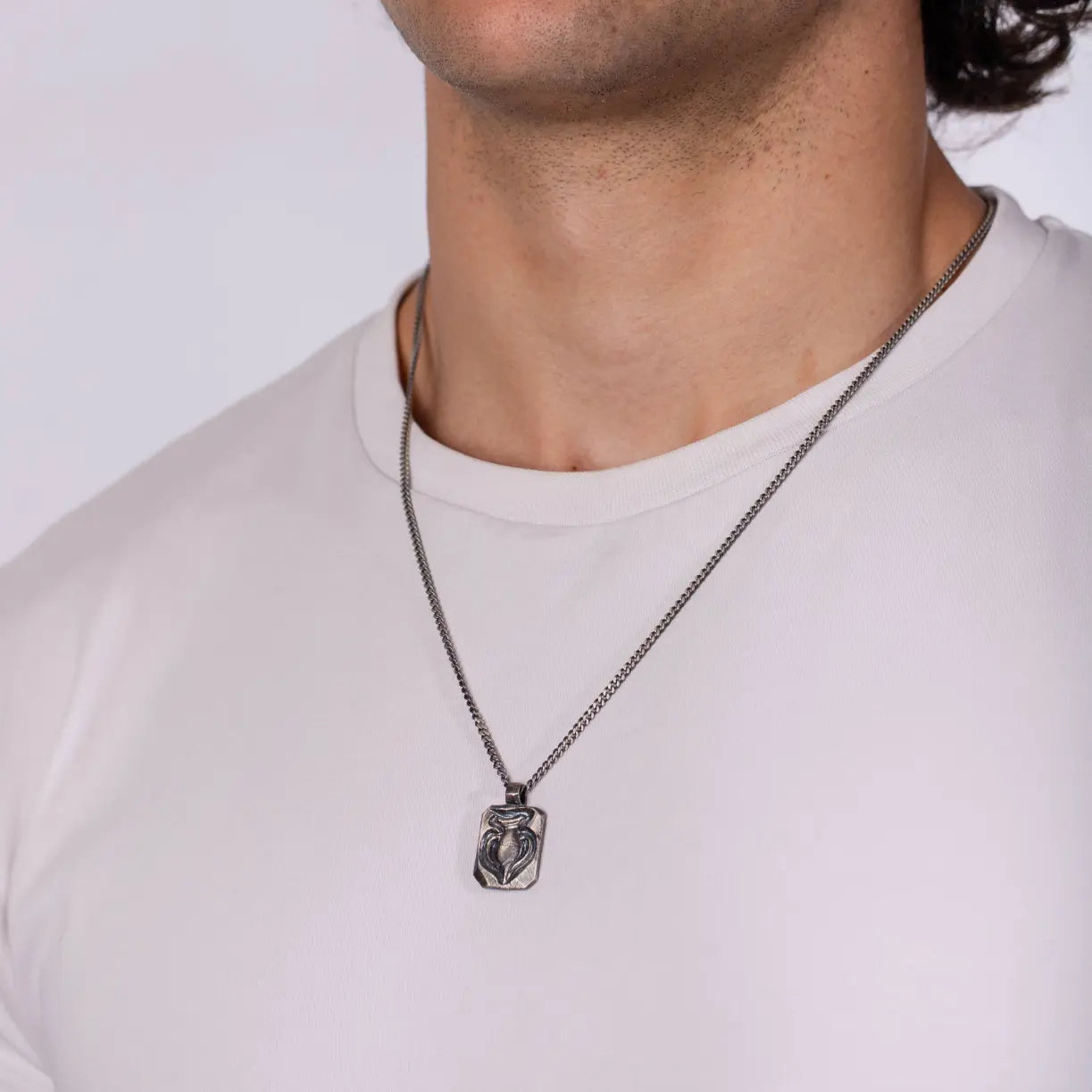 Person wearing Ancient Greek Amphora Necklace Oxidized Silver 925 on a white shirt
