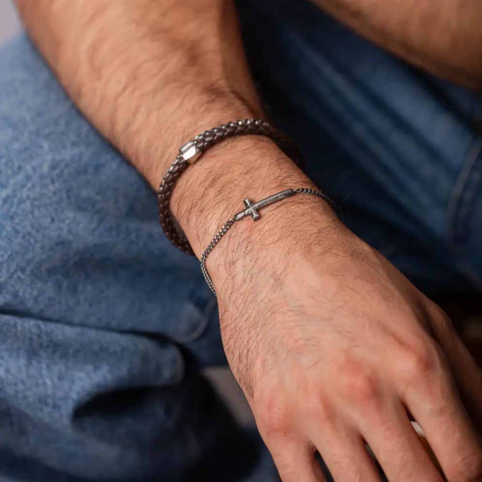 Man wearing Cross Men's Bracelet Oxidized Silver with faceted cross charm and curb chain, made of high quality sterling silver 925.