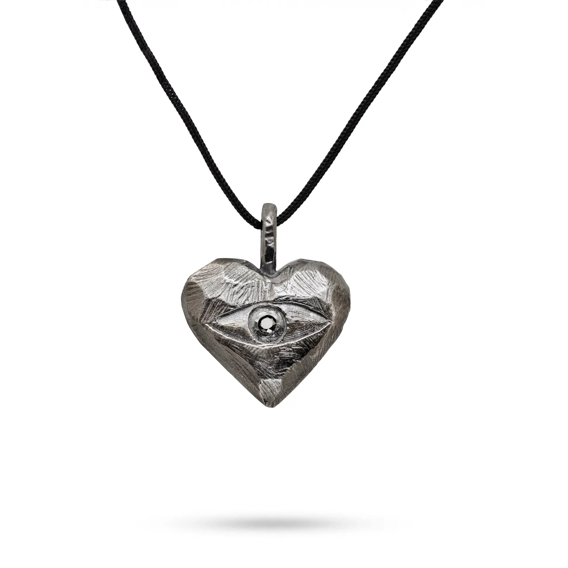 Oxidized silver heart necklace featuring a black diamond on a black cord, perfect as a timeless handcrafted jewelry piece for men and women.